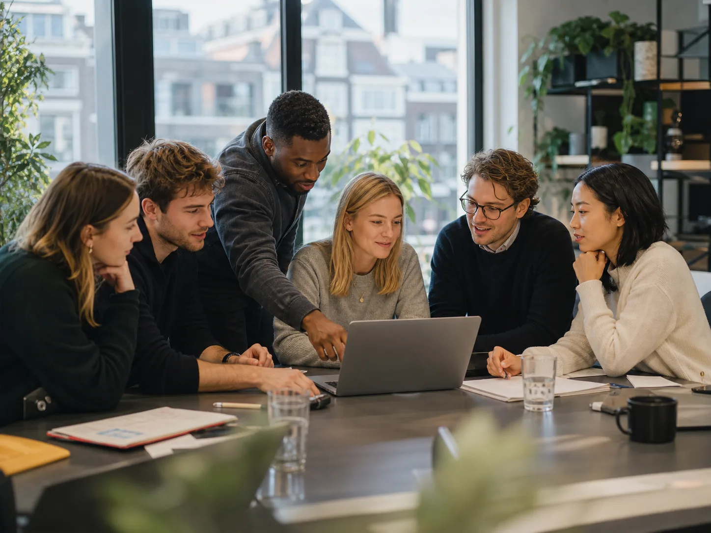 Ainomiq team collaborating in a modern workspace